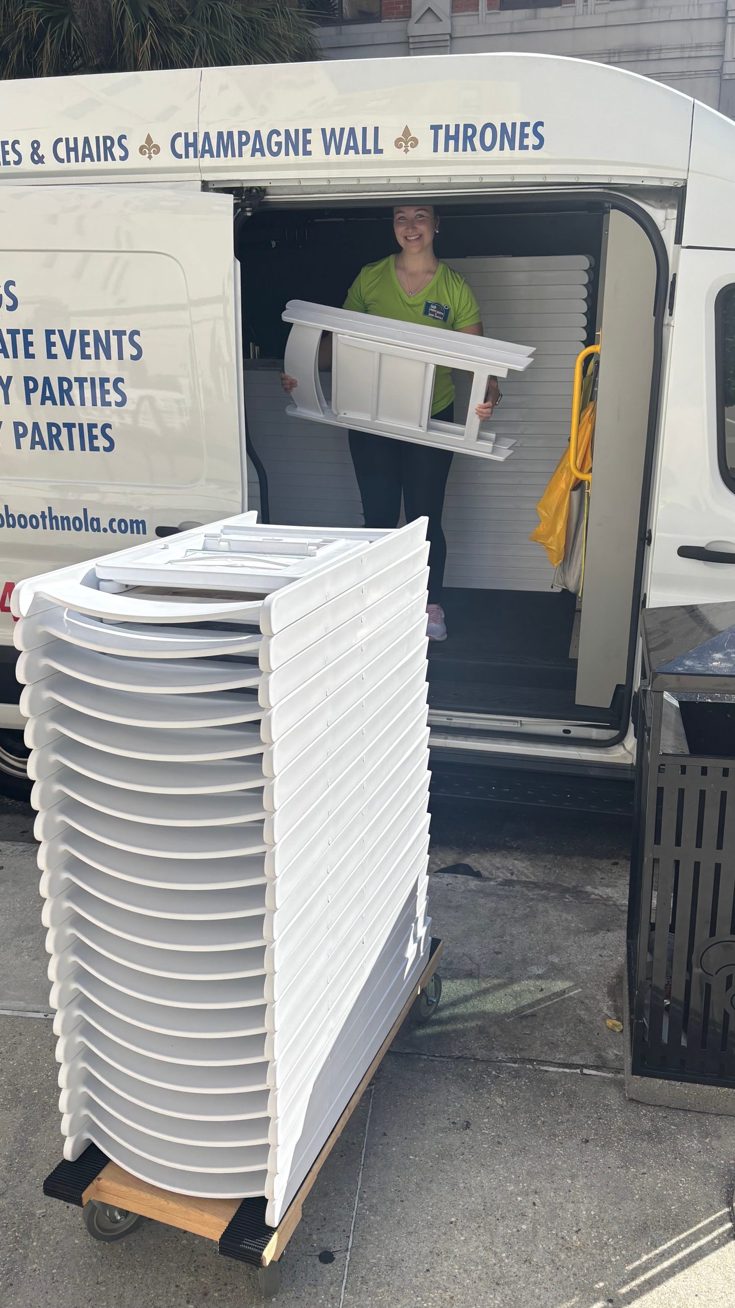 VIP Photo Booth & Event Rental employee unloading chairs from company van