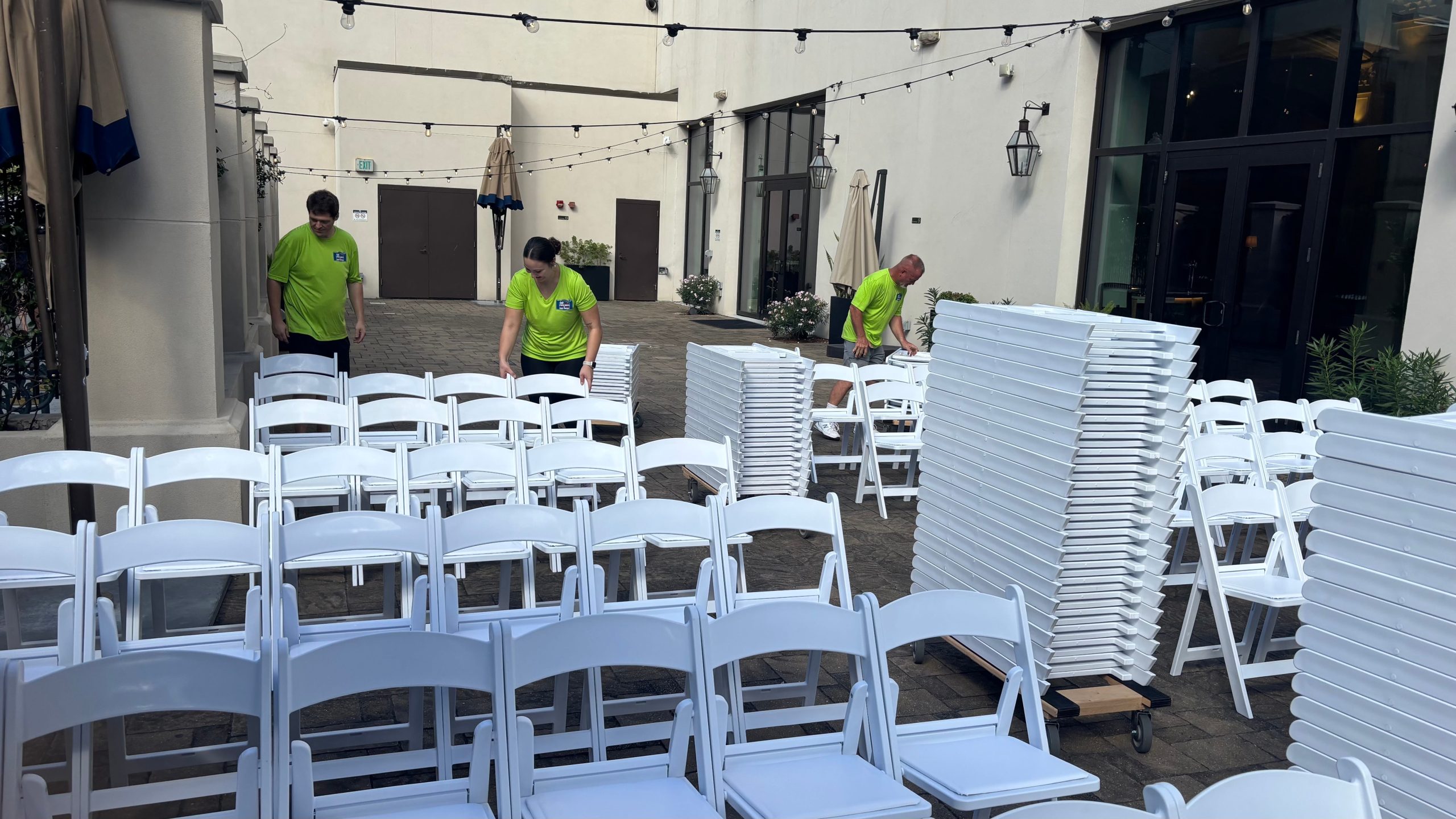 VIP employees lining up rows of chairs setting up for event