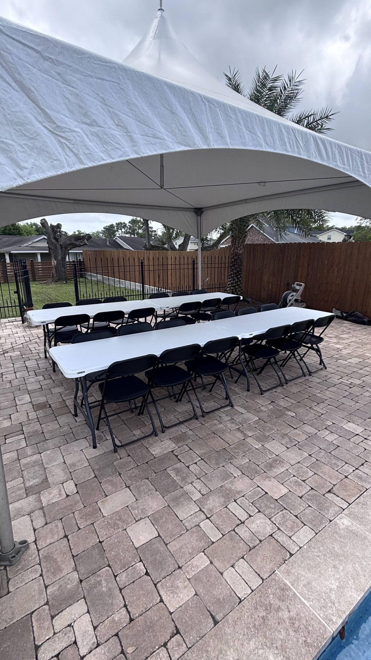 long white tables and black chairs for event rental