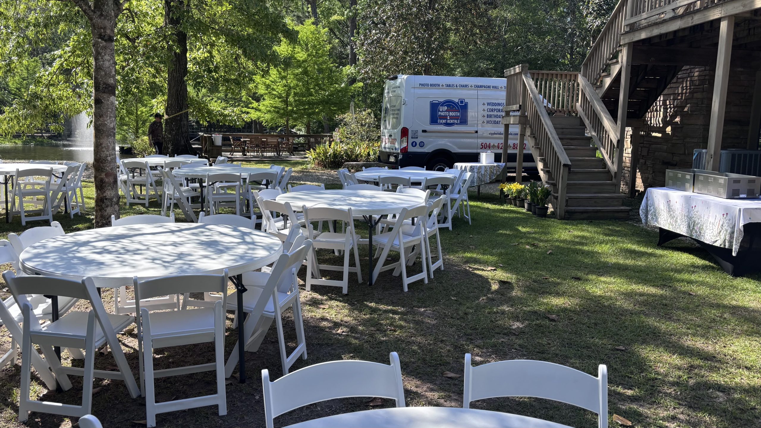 white tables and white chairs rented for event